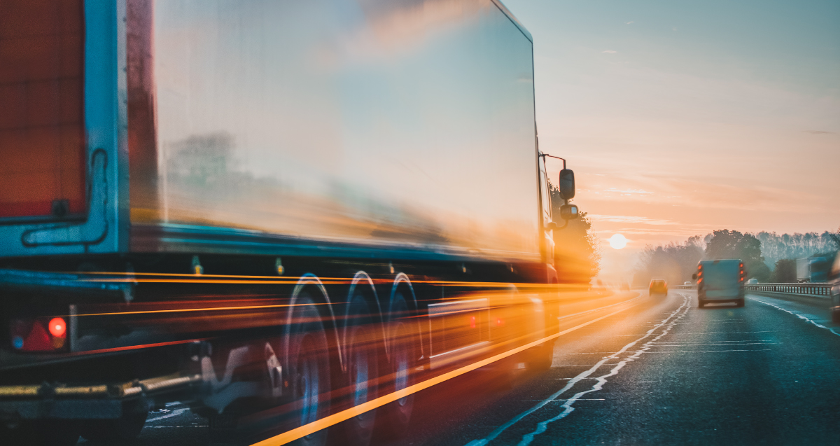 freight truck driving into the sun